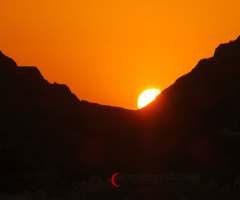 sun is setting down over the moon