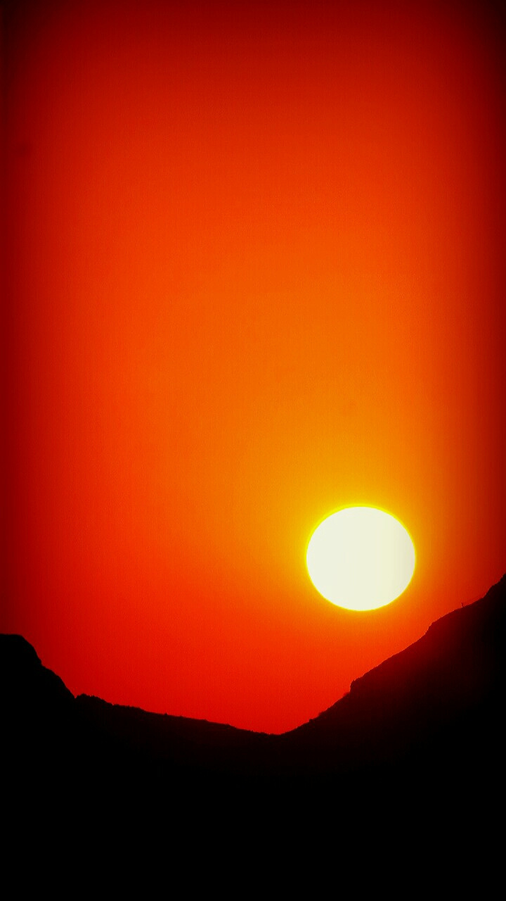The splendid silent sun at the sunset sky directly from my window