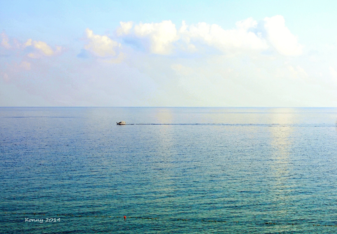 sunlit clouds reflecting in the sea..